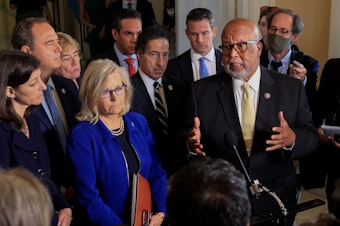 caption: Reps. Bennie Thompson (right) and Liz Cheney, joined by fellow committee members, speak to the media after a July 27 hearing of the House select committee investigating the Jan. 6 attack on the U.S. Capitol.