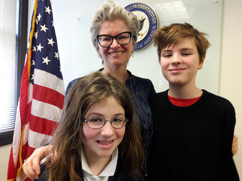 caption: Diana de Forest, HUD employee, with her children.