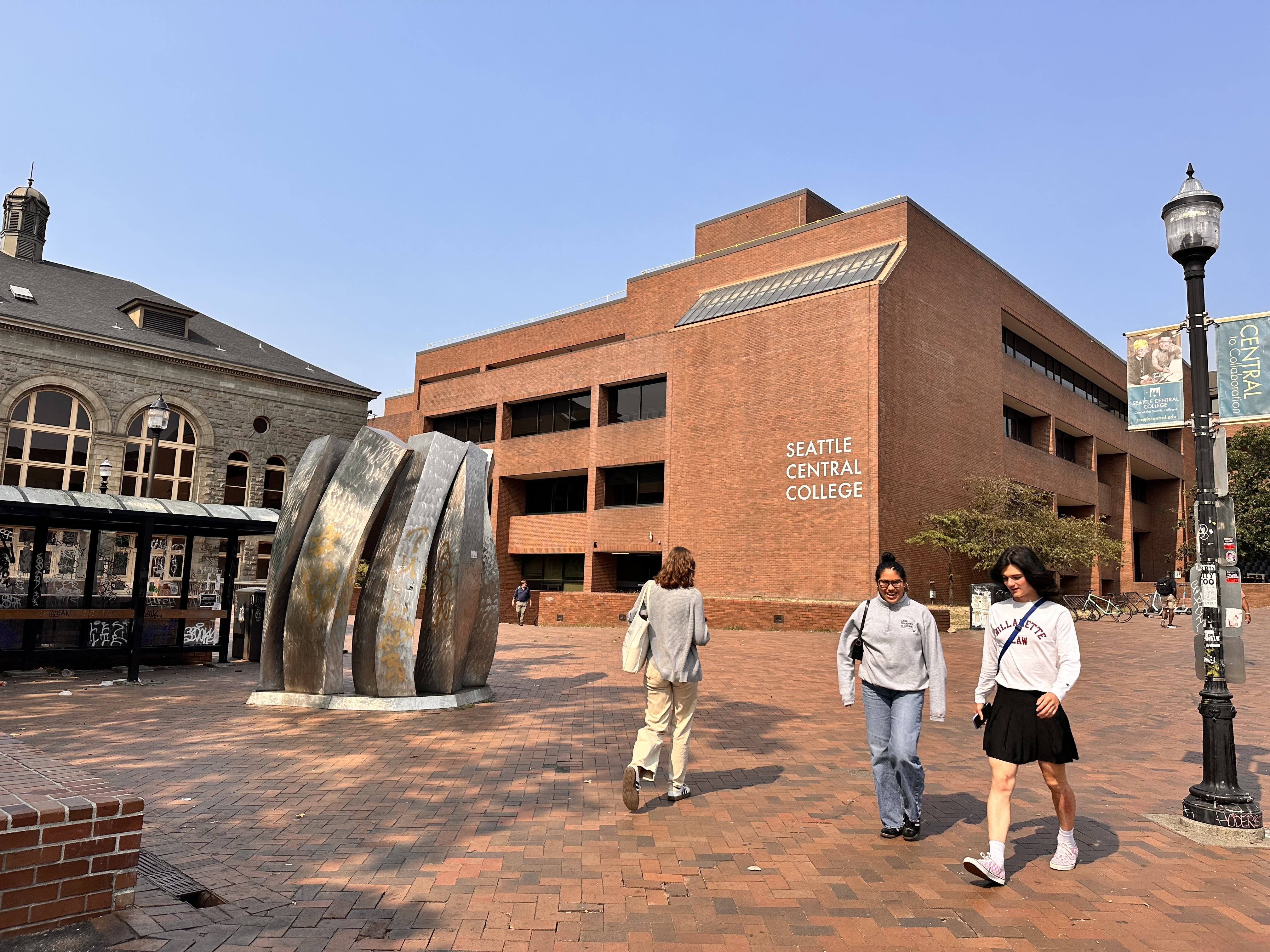 caption: People walk Seattle Central College's campus Sept. 5, 2025. The college has one of the largest international student populations in the country. 