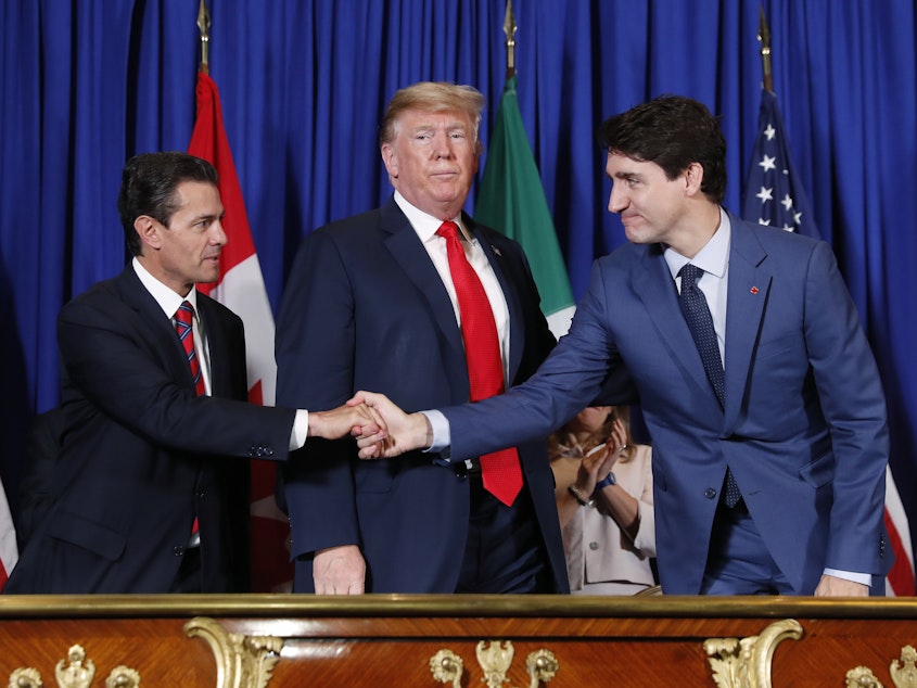 caption: From left, then-Mexican President Enrique Peña Nieto, President Trump and Canadian Prime Minister Justin Trudeau participate in a USMCA signing ceremony in November 2018 in Buenos Aires, Argentina.