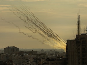 caption: Palestinian militants fire rockets into Israel from Gaza Strip, Oct. 7.