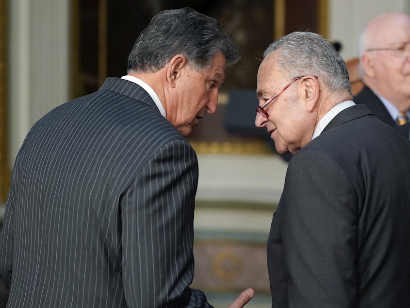 caption: Sen. Joe Manchin, D-W.Va., talks with Senate Majority Leader Chuck Schumer of N.Y., on March 15, 2022.