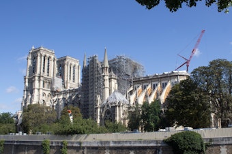 caption: Work on Paris' Notre Dame cathedral continues, following a devastating fire in April.