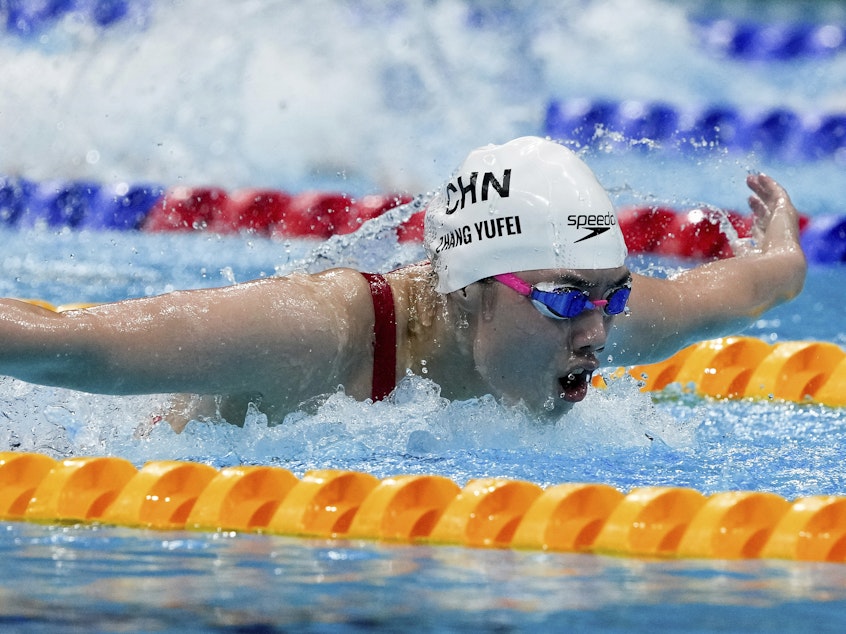 caption: Zhang Yufei of China swims toward an Olympic record and gold medal in the women's 200-meter butterfly final at the Tokyo Olympics.