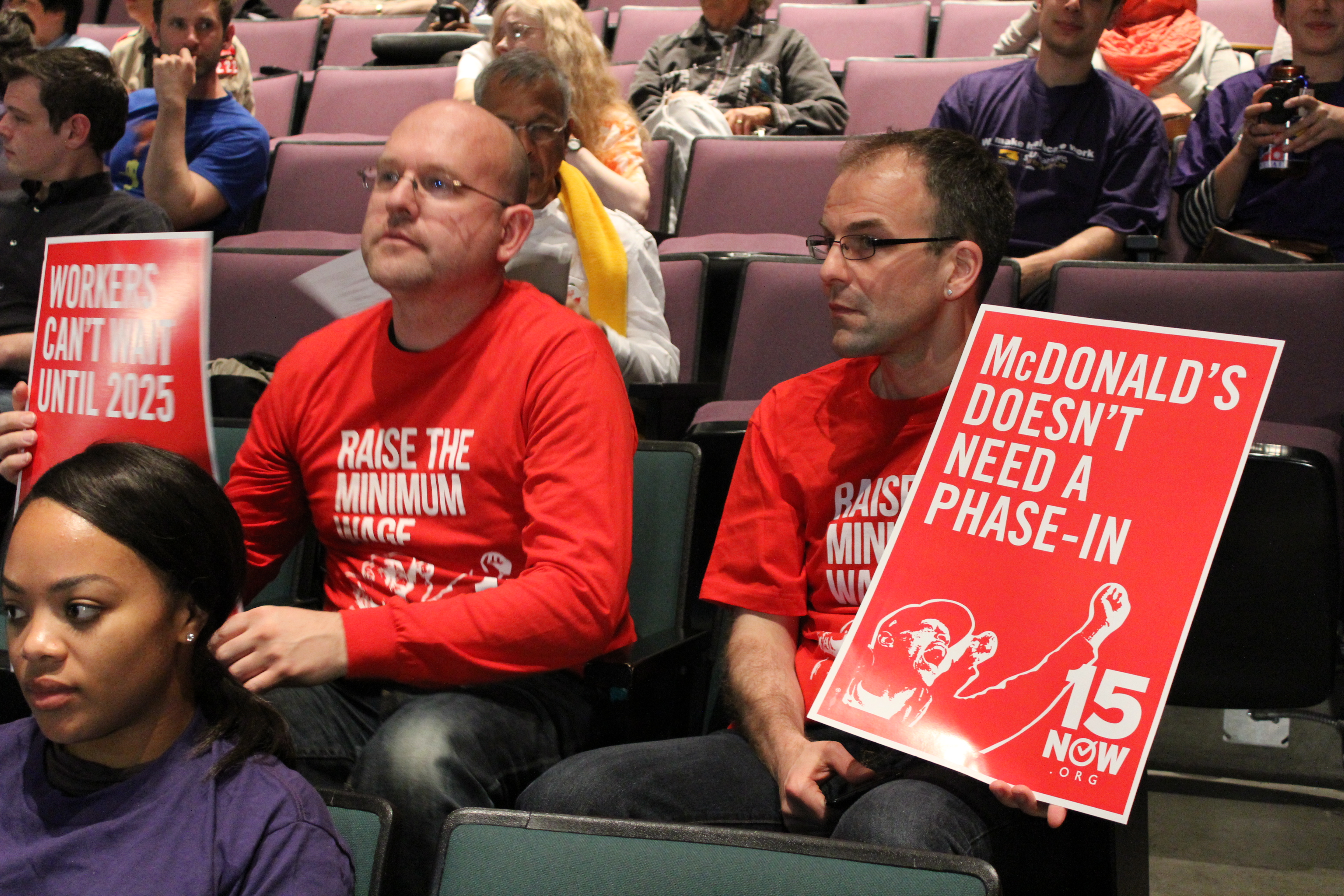 caption: Supporters of the group 15 Now attend a Seattle City Council public meeting to discuss minimum wage on May 13.