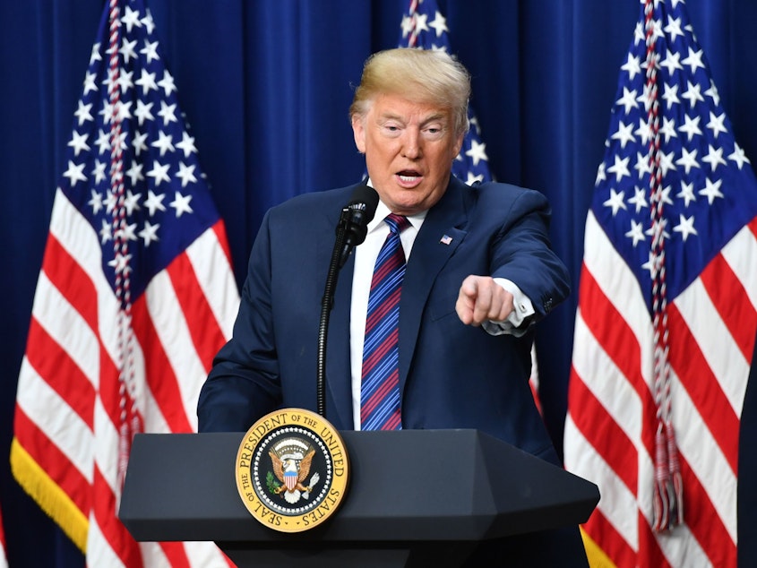 caption: President Trump speaks at the White House in Washington, D.C., in 2018.