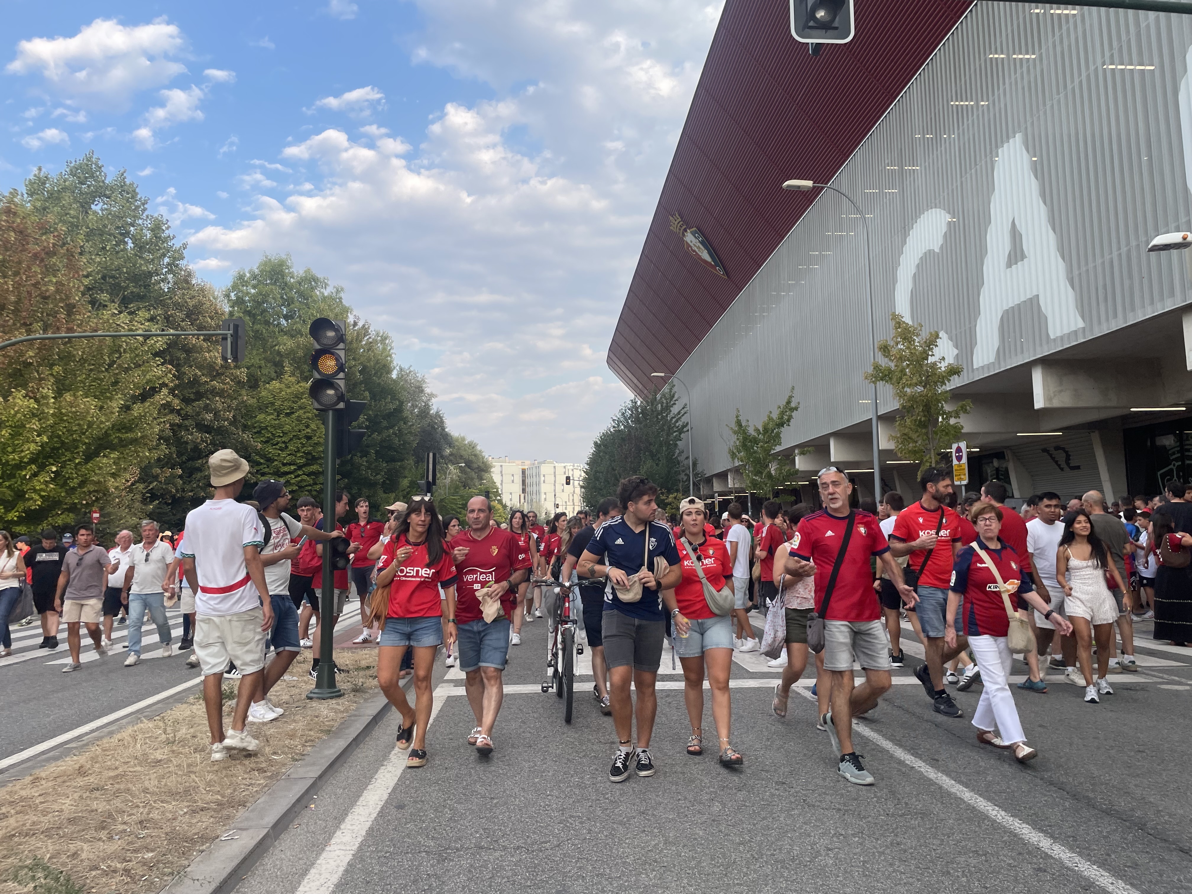 caption: A soccer match has just ended and a river of fans pours out of Pamplona's massive soccer stadium. When a mass of people like this start to move, the laws of physics — rather than free will — begin to take over.