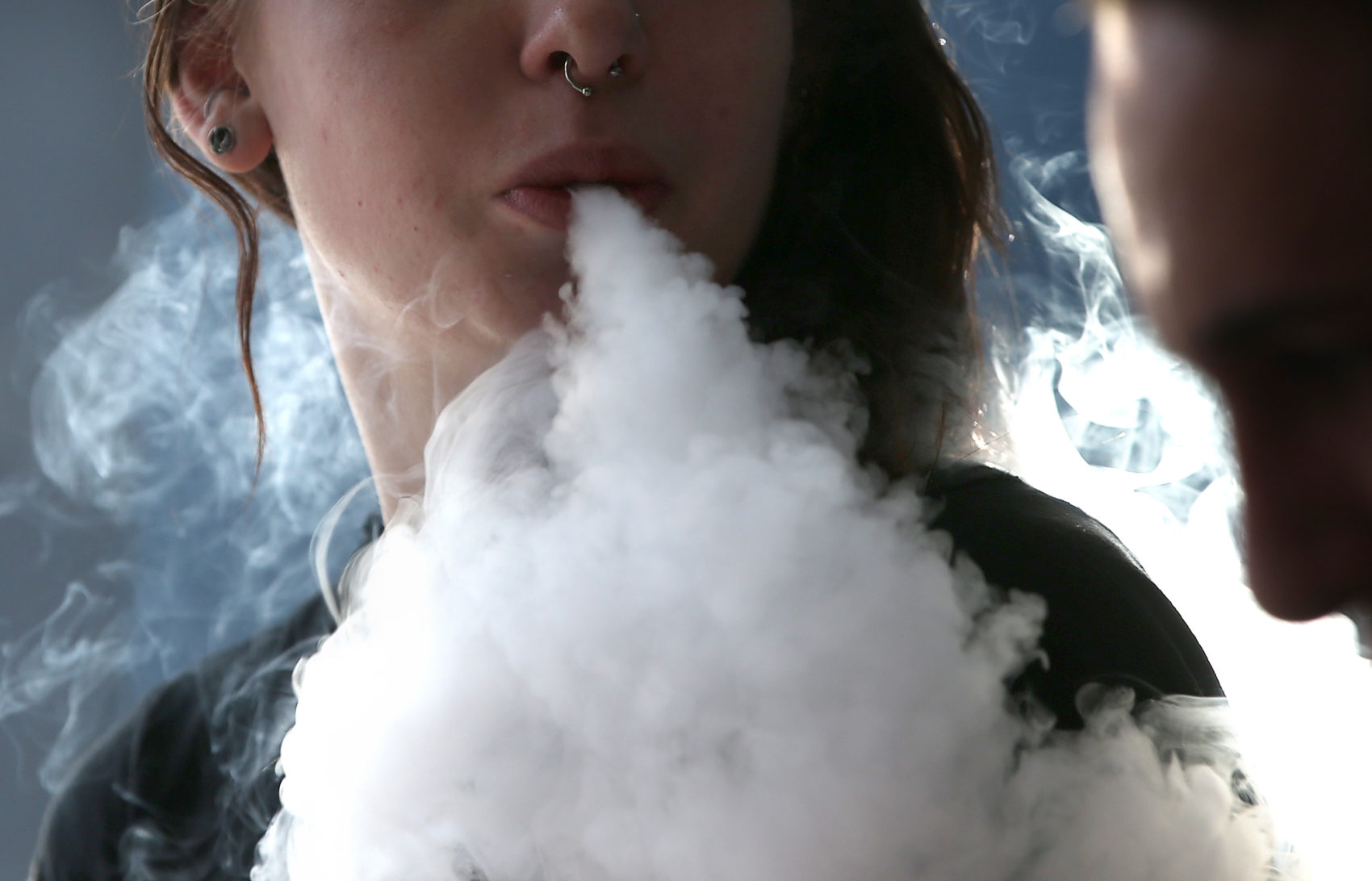 caption: Scientists are still learning new things about the possible health impacts of vaping as the FDA struggles to regulate the booming industry, which could be worth more than $40 billion by 2025. (Justin Sullivan/Getty Images)