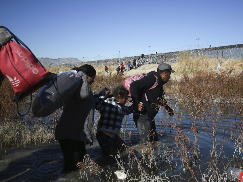 caption: Migrants cross the Rio Grande river to reach the United States from Ciudad Juarez, Mexico, on Wednesday, Dec. 27, 2023.