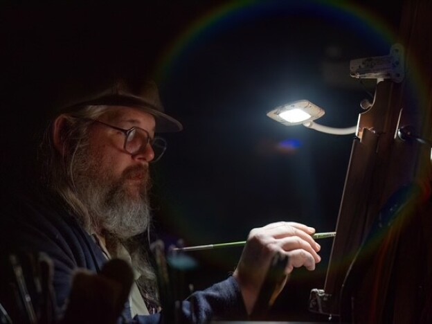 caption: In March 2025, the University of South Alabama presented its Annual Songwriter Keynote, a conversation and concert event funded, in part, by a grant from the Alabama Humanities Alliance. Gulf Coast artist Robby Amonett, pictured above, live-painted the event.