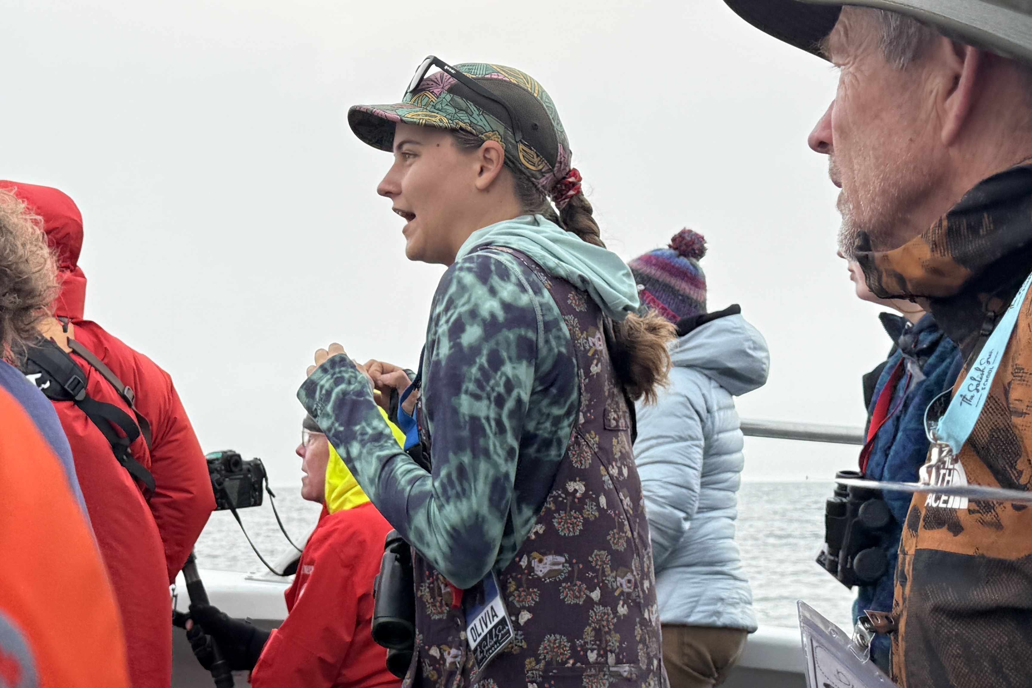 caption: Salish Sea School naturalist Olivia Fross interprets on board the Koinonia tour boat off Smith Island, Washington, on Sept. 6, 2025. 