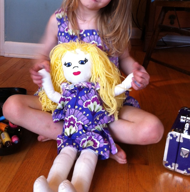caption: M with her baby doll.