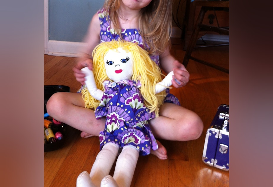 caption: M with her baby doll.