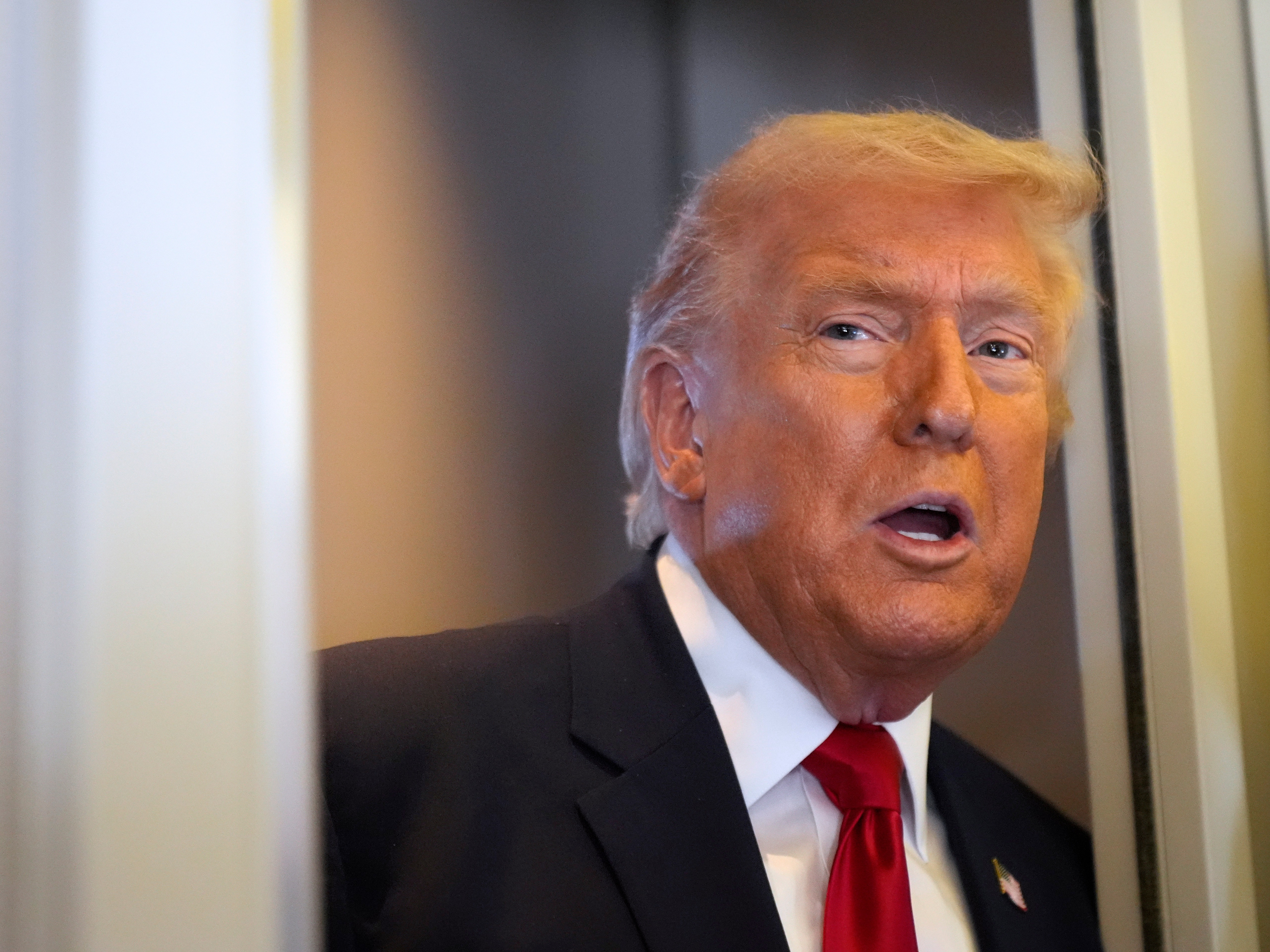 caption: President Donald Trump speaks to reporters while traveling aboard Air Force One en route from Dover Air Force Base, Del., to Miami, Saturday, March 7, 2026. (AP Photo/Mark Schiefelbein)
