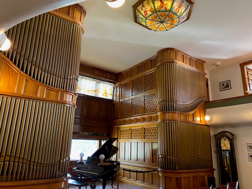 caption: The centerpiece of the Moran Museum is a music room featuring a two-story Aeolian pipe organ that dates back to 1913. Between the organ pipes is a 1900 Steinway grand piano. Above is a Belgian stain-glass window and an original Tiffany chandelier. 