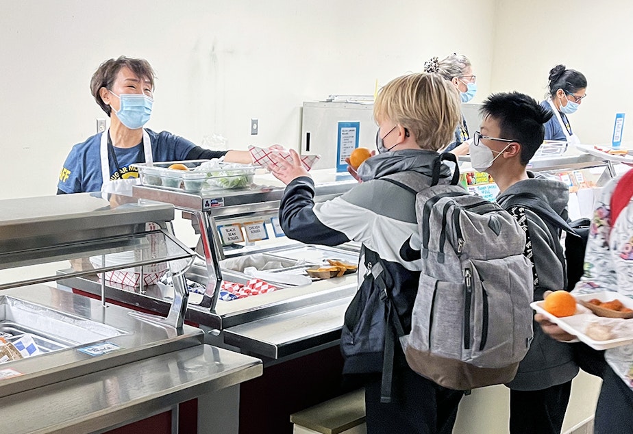 caption: Students at Cougar Mountain Middle School getting lunch in the cafeteria.