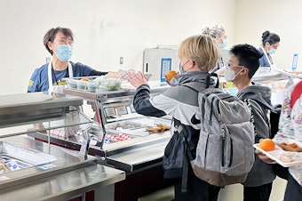 caption: Students at Cougar Mountain Middle School getting lunch in the cafeteria.