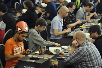 caption: Players compete in a <em>Magic: The Gathering</em> tournament at Hasbro's HASCON in 2017.