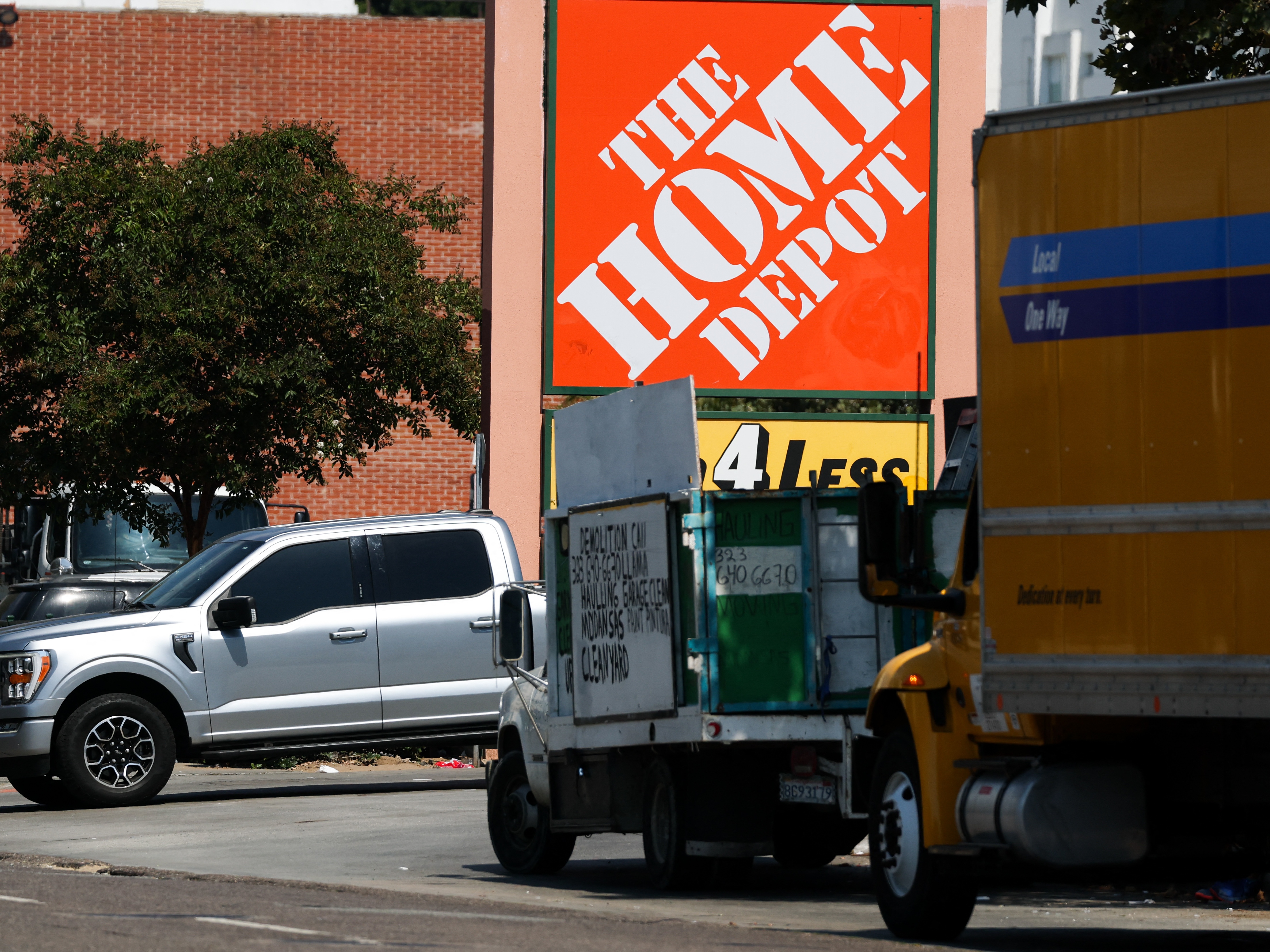 caption: The Home Depot logo is displayed outside a store in Los Angeles where immigration agents arrested day laborers after jumping out of a rental moving truck.