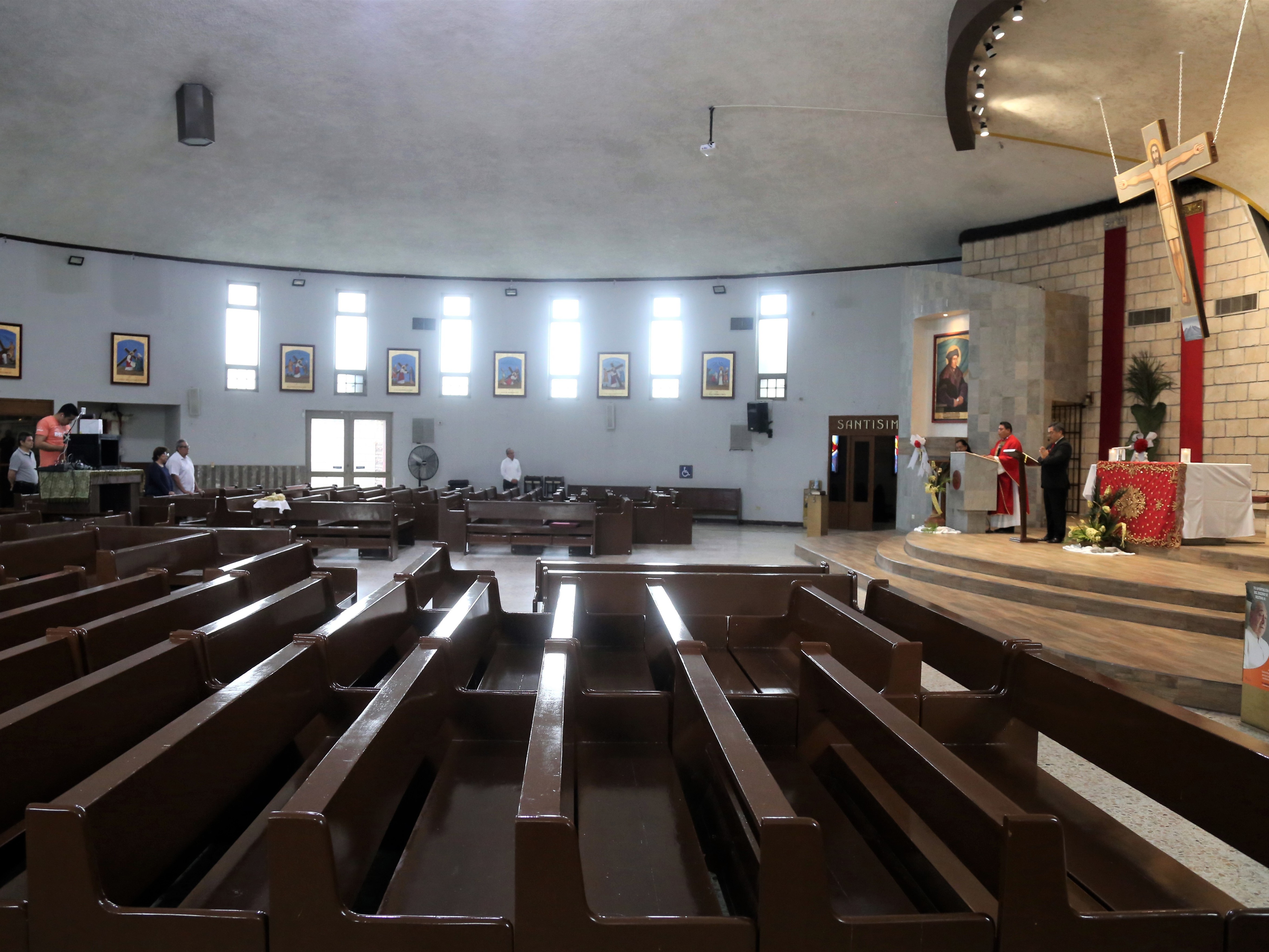 caption: Felipe Samaniego officiates at a Roman Catholic Mass, streamed via Facebook from the Santo Tomás Moro church on Palm Sunday, in Monterrey, Mexico.