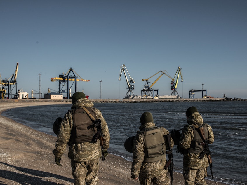 caption: Ukraine's Border Security Force soldiers patrol the coast of the Azov Sea near Mariupol Port on Thursday.