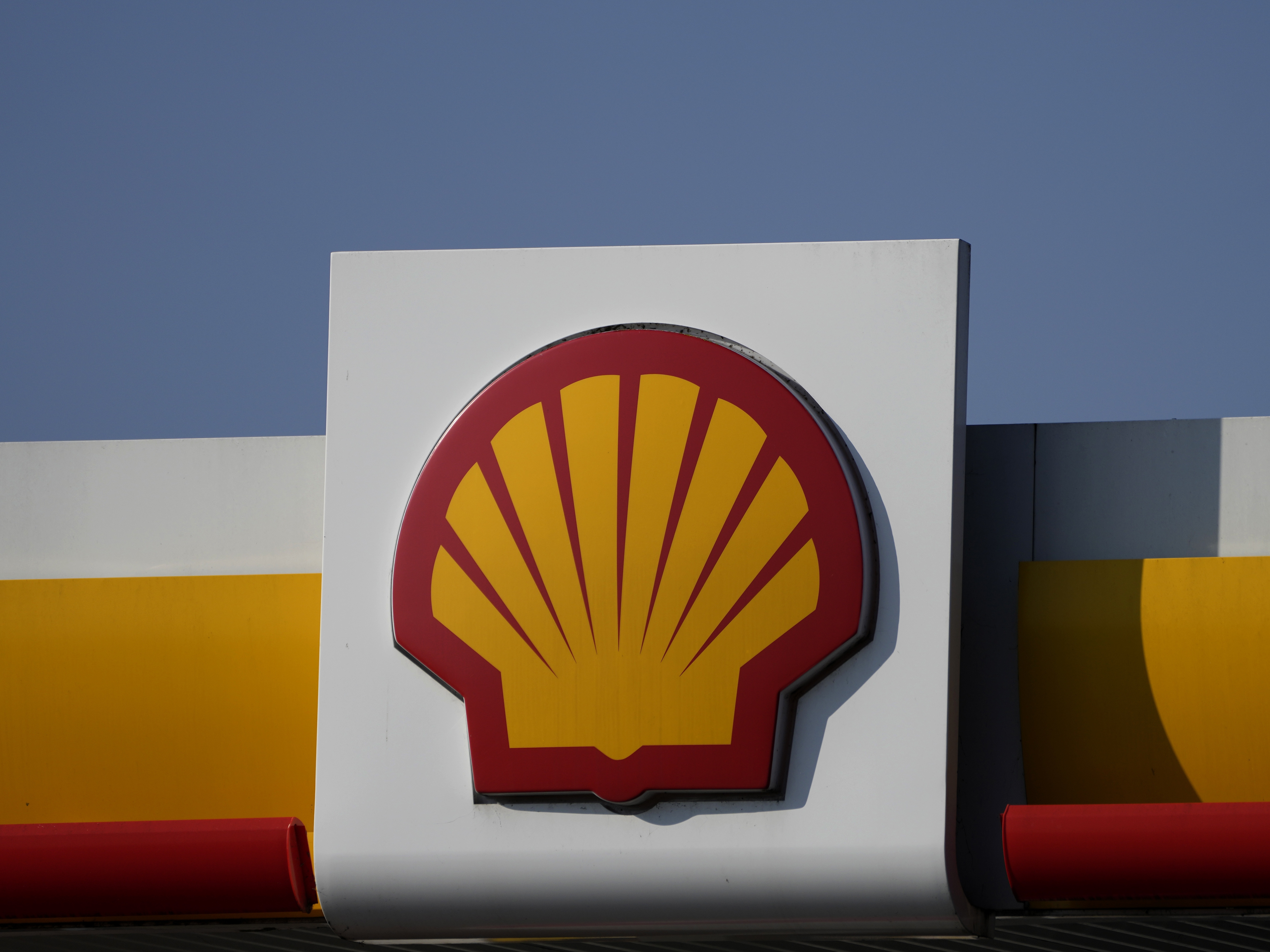 caption: An earlier ruling had ordered energy company Shell to cut its carbon emissions by net 45% by 2030 compared to 2019 levels. A Shell logo is displayed at a gas station in London in March 2022.