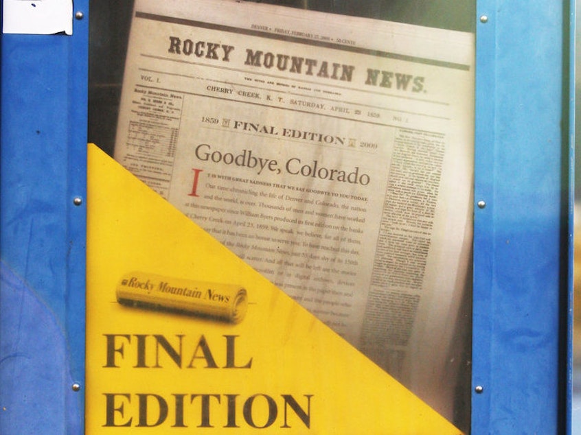 caption: A copy of the final edition of the Rocky Mountain News sits in a newspaper box on a street corner in Denver, Colorado.