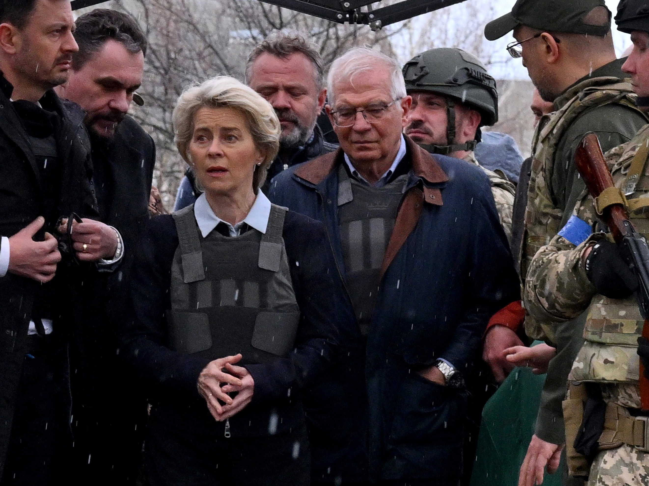 caption: Slovakian Prime Minister Eduard Heger (left), European Commission President Ursula von der Leyen and European Union High Representative for Foreign Affairs and Security Policy Josep Borrell visit a mass grave in the town of Bucha on Friday.