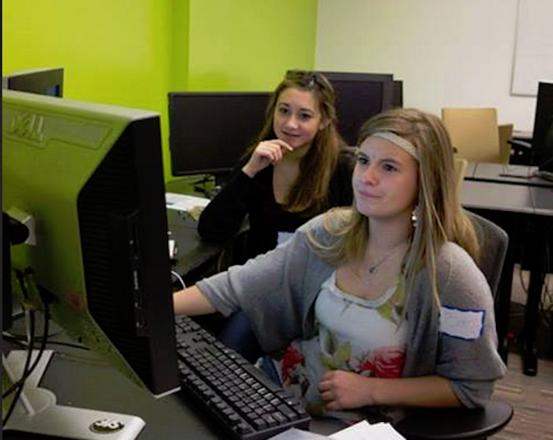 caption: Elizabeth Brace, right, works on coding at a University of Washington camp. 