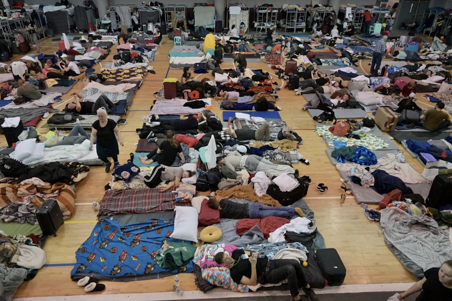 caption: Volunteers worked with Tijuana officials to turn a municipal sports complex into a shelter to house thousands as they wait for their turn to be processed at the border.