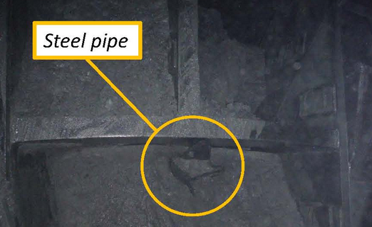 caption: A glimpse of the steel pipe burrowing into Bertha.