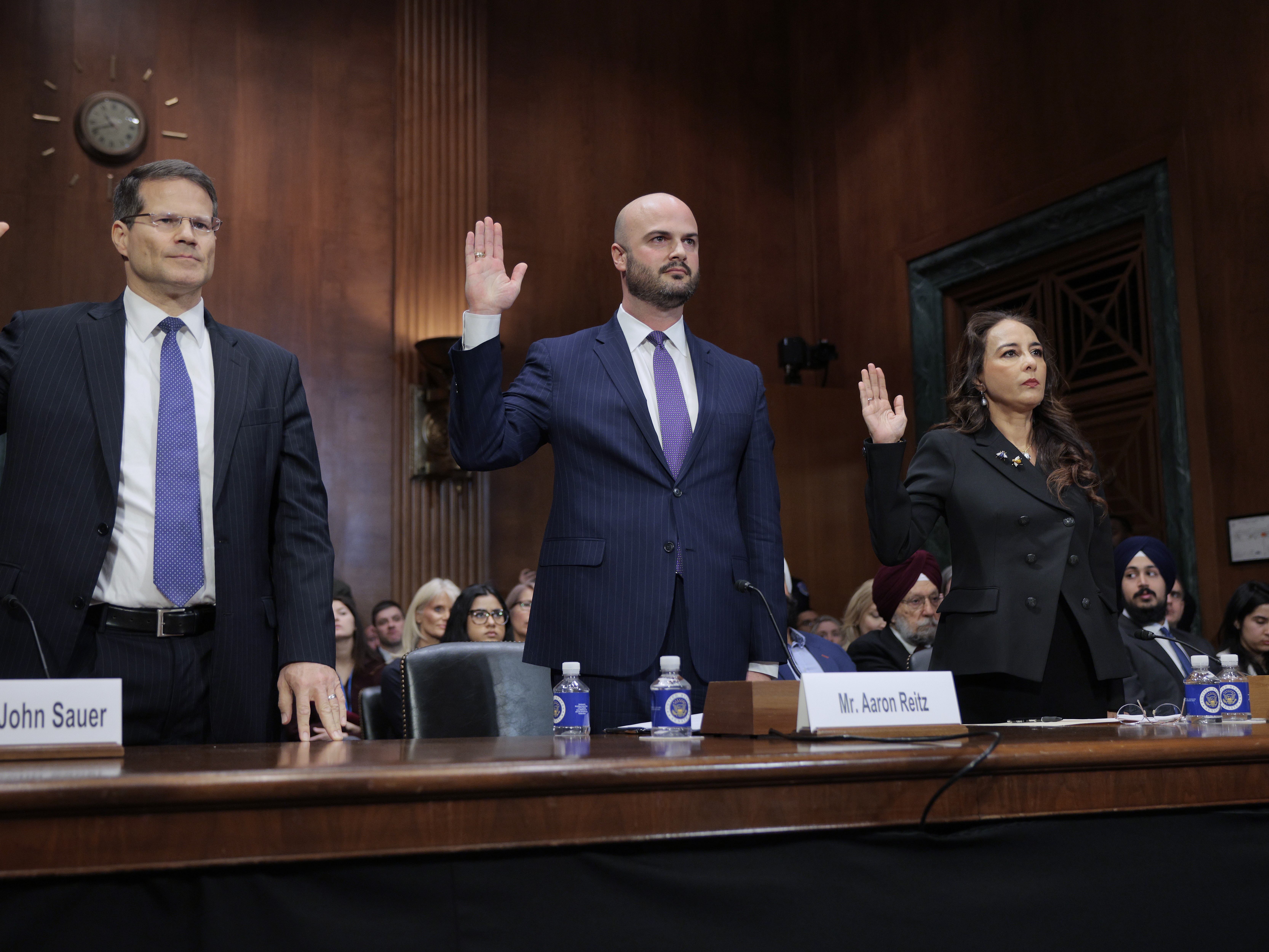 caption: Harmeet Dhillon, far right, is sworn in during her confirmation hearing before the Senate Judiciary Committee in February 2025 in Washington, D.C.