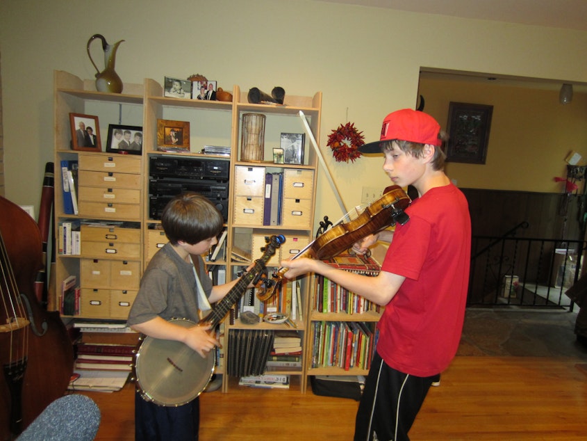 caption: Eli and Oliver Abrahamson at home in 2012. The Abrahamson boys and their family got their start busking at the Northwest Folklife Festival as the Smalltime String Band.
