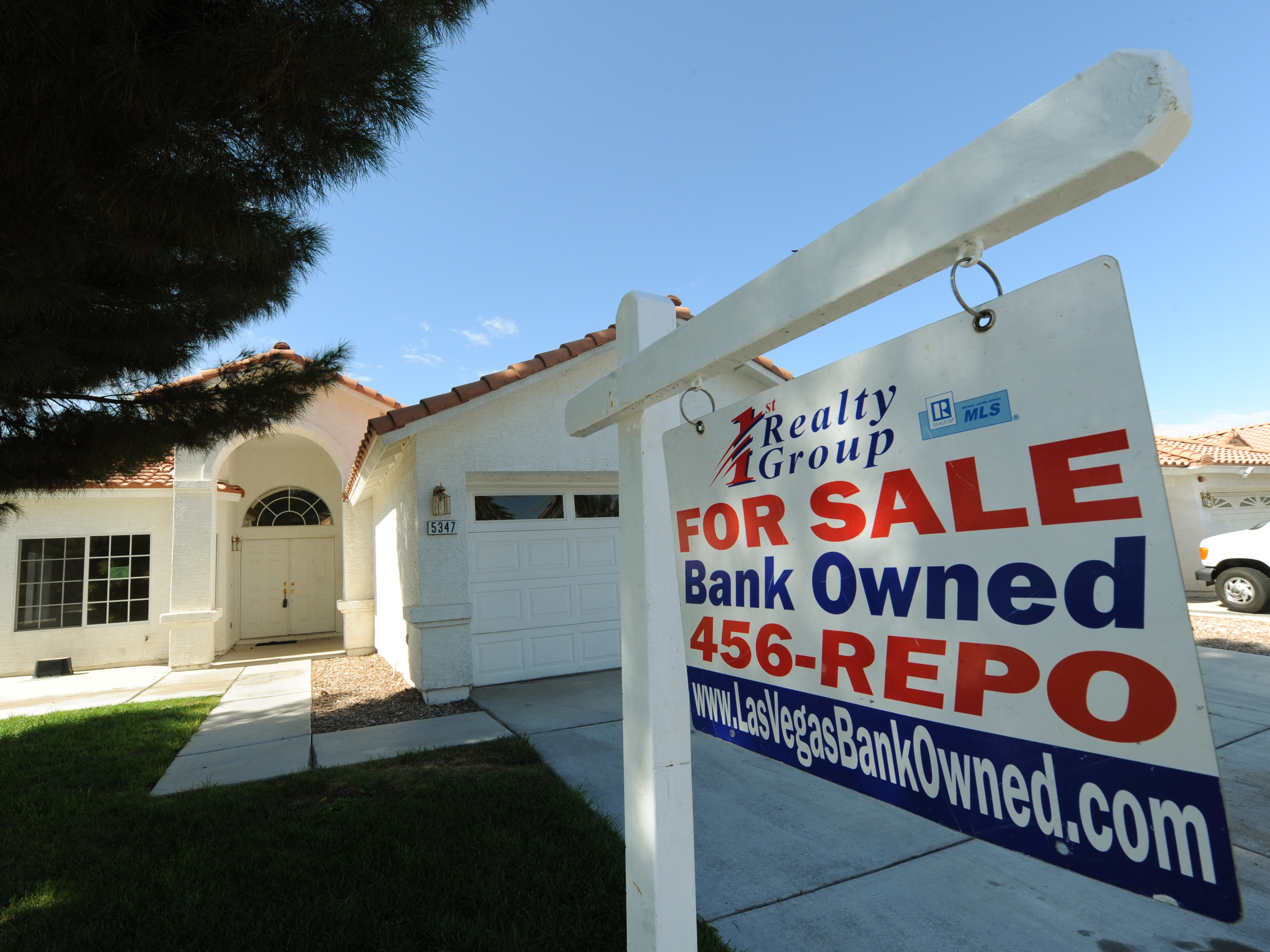 caption: A house under foreclosure in Las Vegas displays a sign on Oct. 15, 2010, saying that it's now bank-owned. Sen. Sherrod Brown has vowed increased scrutiny of Wall Street banks, in part after a surge in foreclosures in his hometown in Ohio over a decade ago.