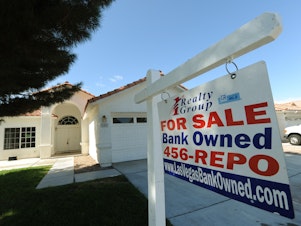 caption: A house under foreclosure in Las Vegas displays a sign on Oct. 15, 2010, saying that it's now bank-owned. Sen. Sherrod Brown has vowed increased scrutiny of Wall Street banks, in part after a surge in foreclosures in his hometown in Ohio over a decade ago.