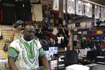 caption: Moe Toure runs Toure Apparel in a strip mall on one of Vulcan Real Estate's 23rd Avenue properties.