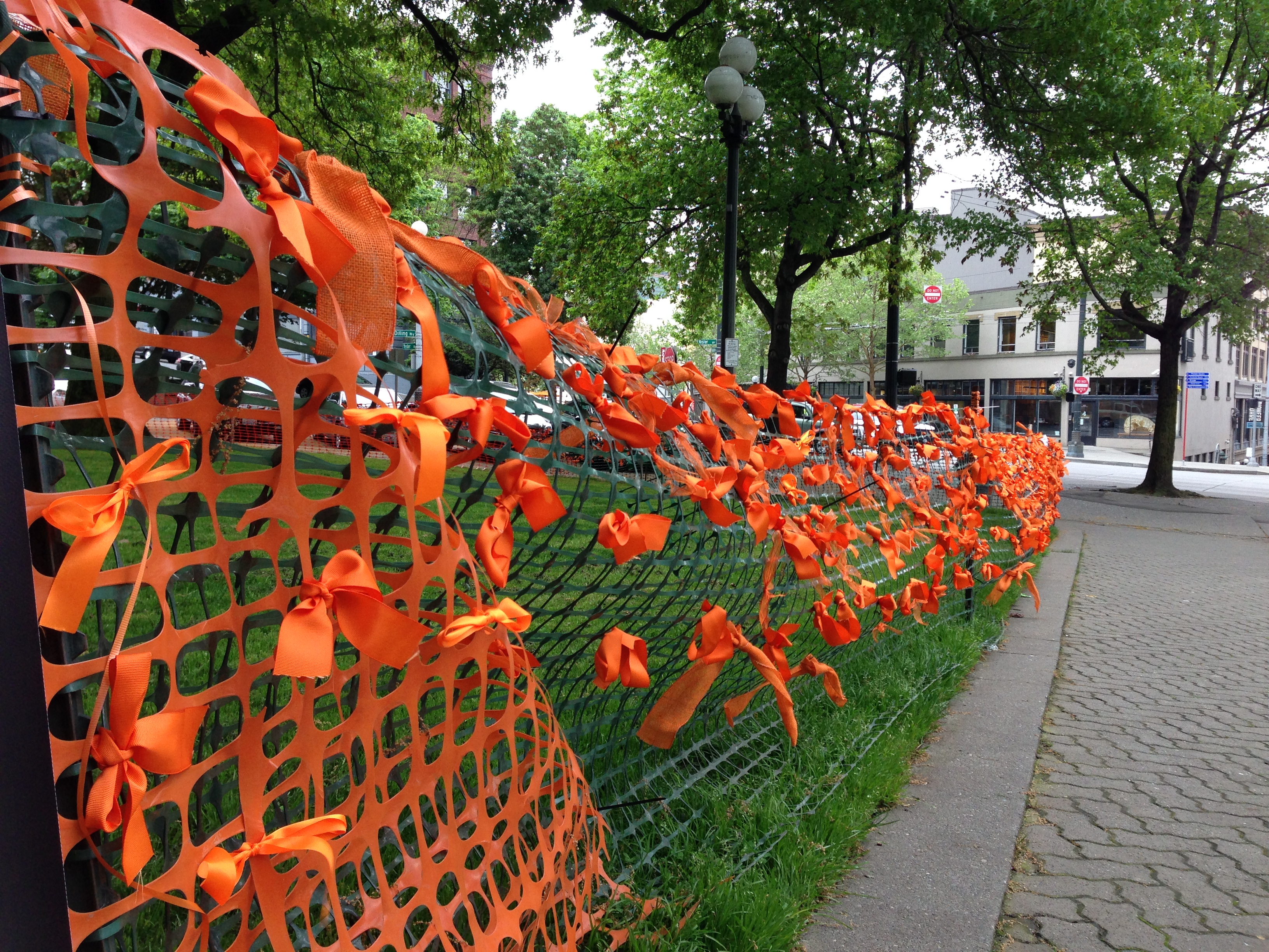 caption: At a recent gathering, supporters of a safe site for drug users tied a ribbon to remember people who've been personally affected by substance abuse.