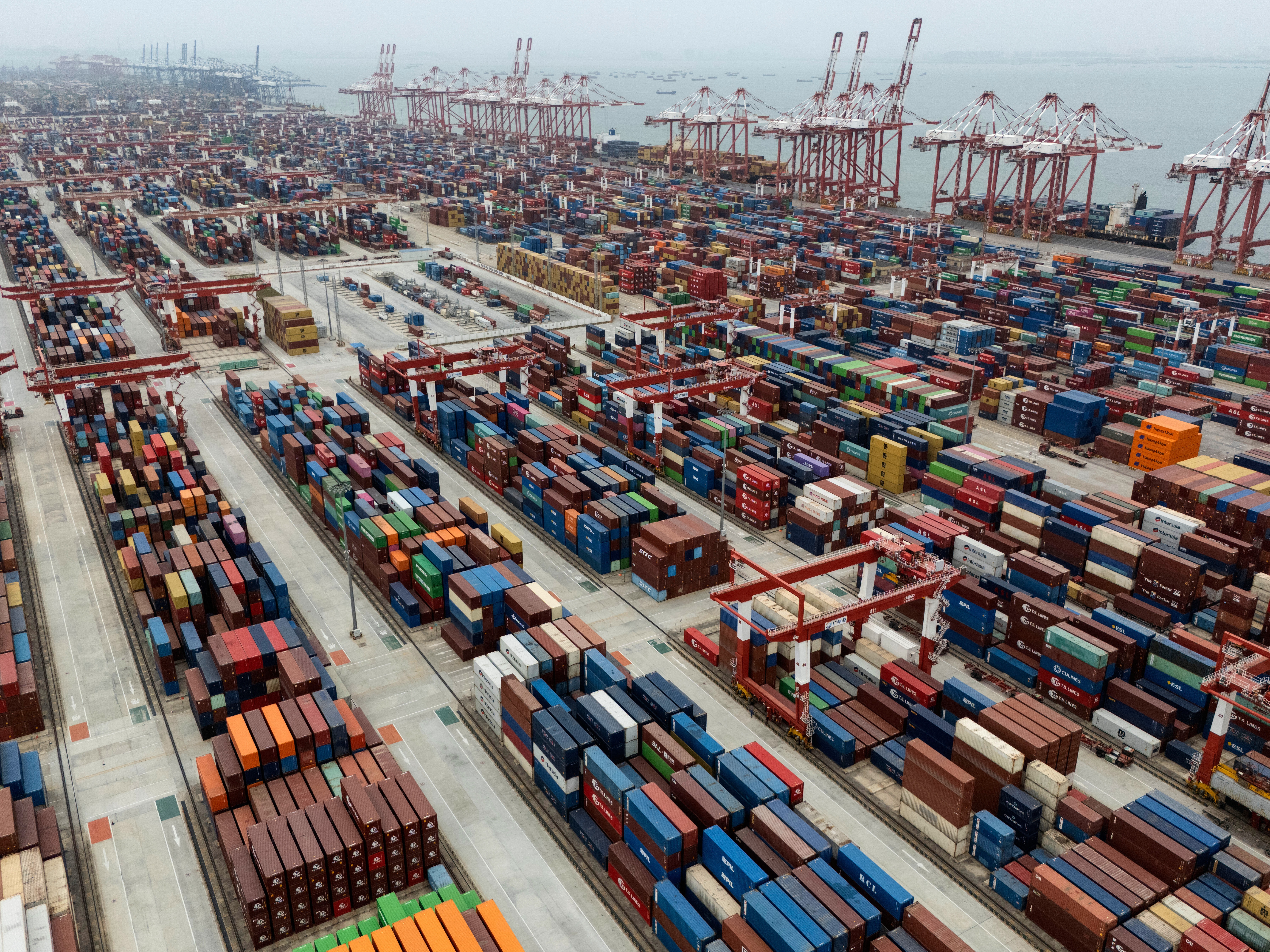 caption: Shipping containers are seen ready for transport at the Guangzhou Port in southern China's Guangdong province on April 17.
