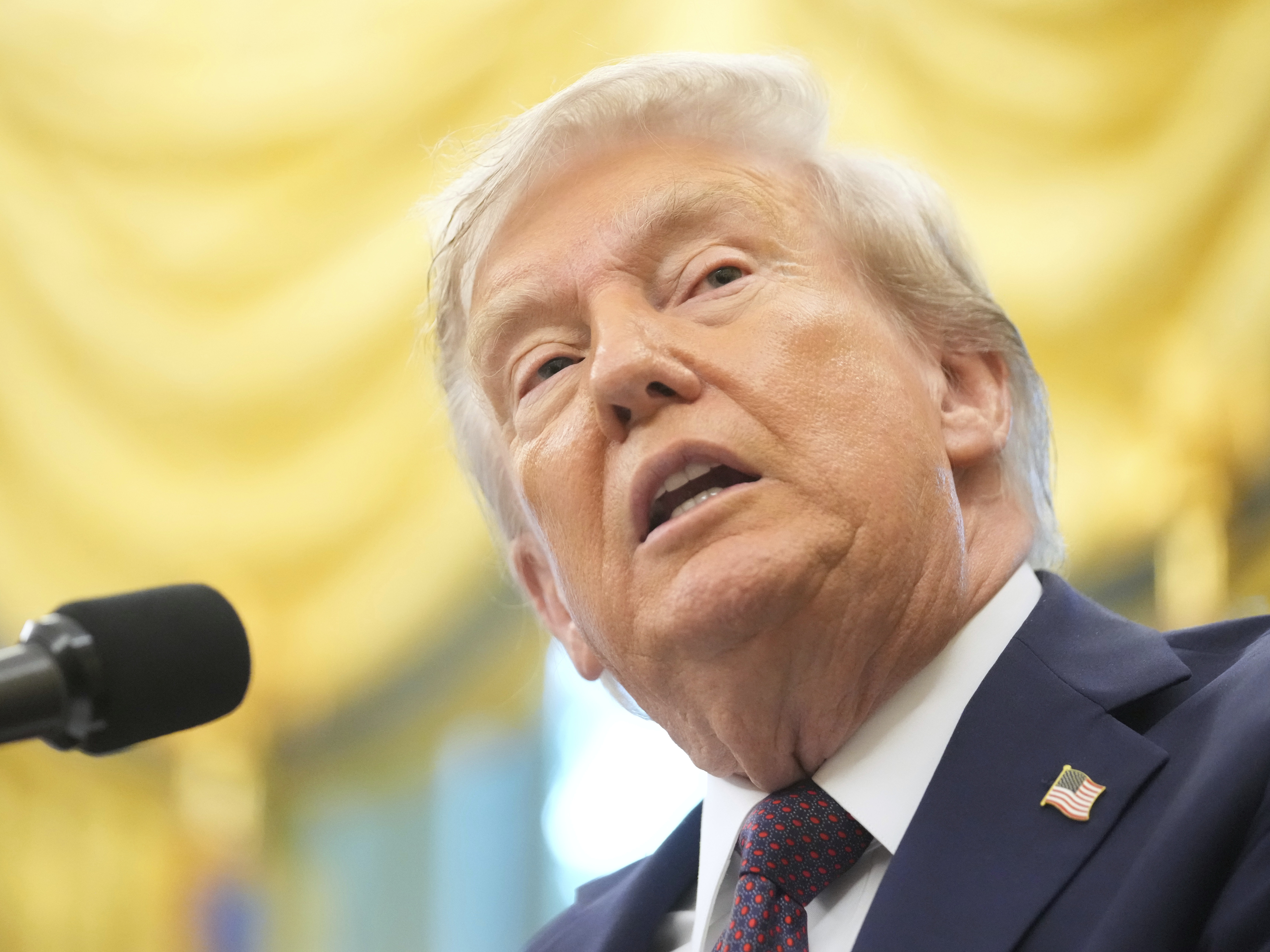 caption: President Trump speaks during an event in the Oval Office of the White House on Tuesday.
