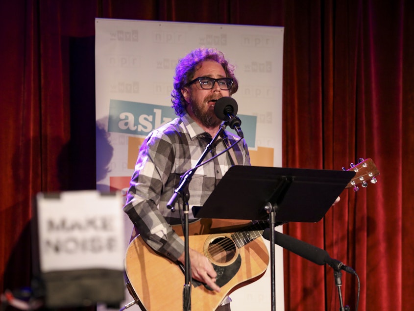 caption: House musician Jonathan Coulton leads a parody game on Ask Me Another at the Bell House in Brooklyn, New York.