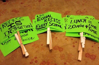 caption: Signs promote lunch and recess for Seattle students.
