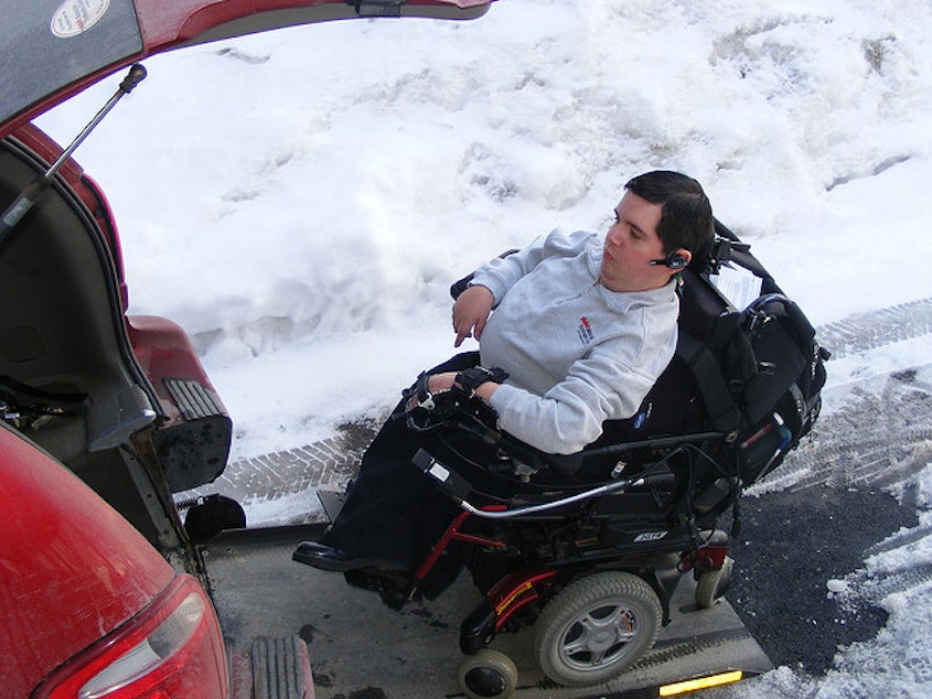 caption: FILE: A man with muscular dystrophy navigates snowy conditions. 