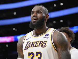 caption: Los Angeles Lakers forward LeBron James looks toward fans after scoring during the second half of an NBA basketball game against the Denver Nuggets Saturday, March 2, 2024, in Los Angeles.