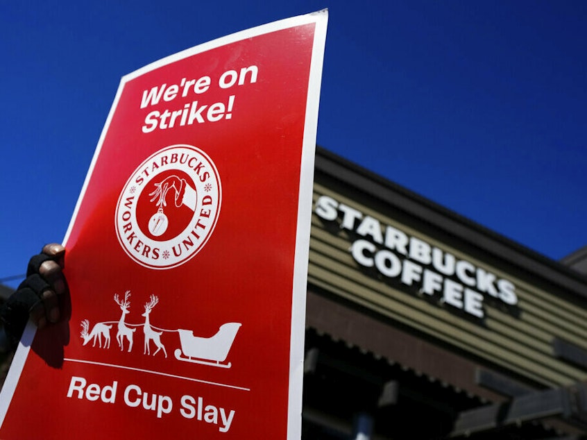 caption: Starbucks employees strike Nov. 17 outside their store in Mesa, Ariz. Starbucks workers around the U.S. are planning a three-day strike starting Friday as part of their effort to unionize the coffee chain's stores.