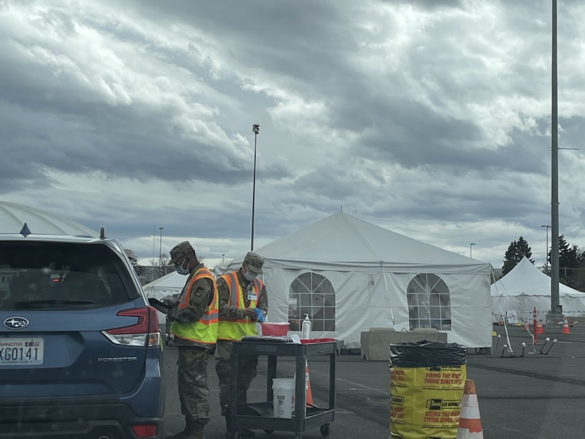 caption: Staff with the U.S. National Guard vaccinate people against Covid-19 in Yakima, WA on Easter Sunday 2021. The FEMA site is designed to vaccinate 1,200 people a day, with the potential to serve 3,000. 