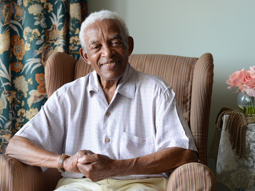 caption: Irving Burgie at his home in Queens in 2017. Burgie, who rewrote the lyrics to the traditional Jamaican song "Day-O," died on Friday, Nov. 29, at the age of 95.