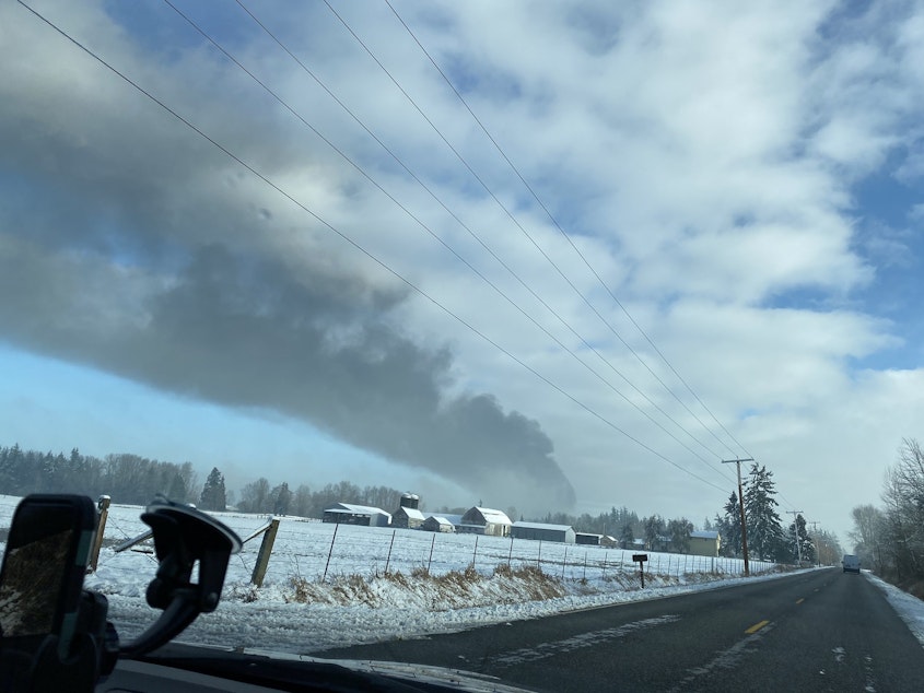 caption: Smoke from an oil train that derailed Dec. 22 in Custer could be seen from miles away.