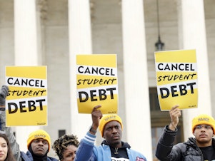 caption: Student loan borrowers and advocates gather for the People's Rally To Cancel Student Debt During The Supreme Court Hearings On Student Debt Relief on February 28, 2023 in Washington, DC.