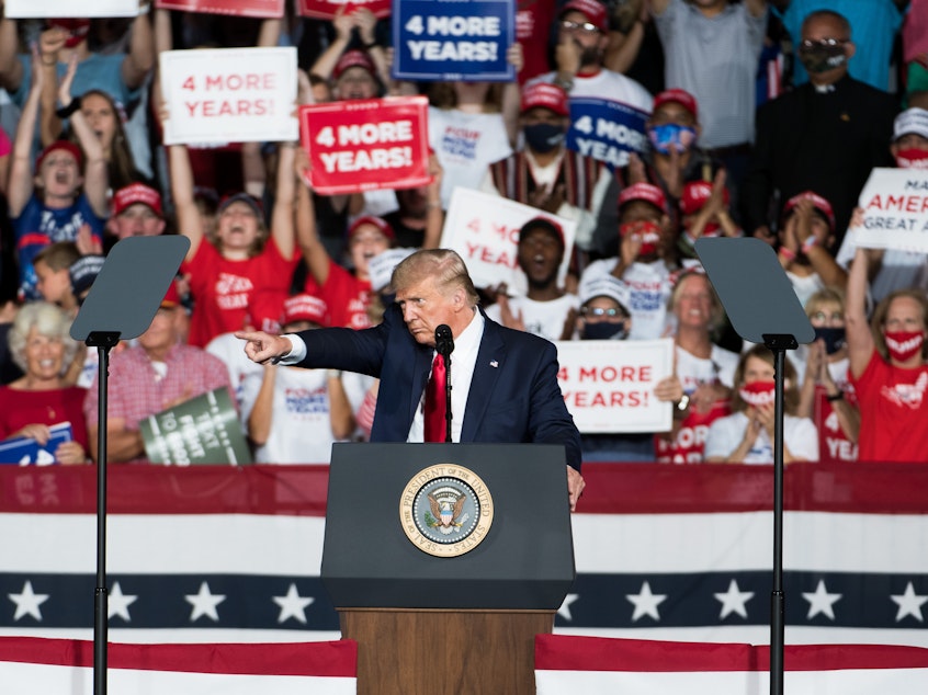 caption: President Trump addresses the crowd during a campaign rally Tuesday at Smith Reynolds Airport in Winston Salem, N.C.