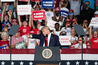 caption: President Trump addresses the crowd during a campaign rally Tuesday at Smith Reynolds Airport in Winston Salem, N.C.